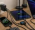 GaN charger powering a smartphone, tablet and laptop with braided USB-C cables on a desk